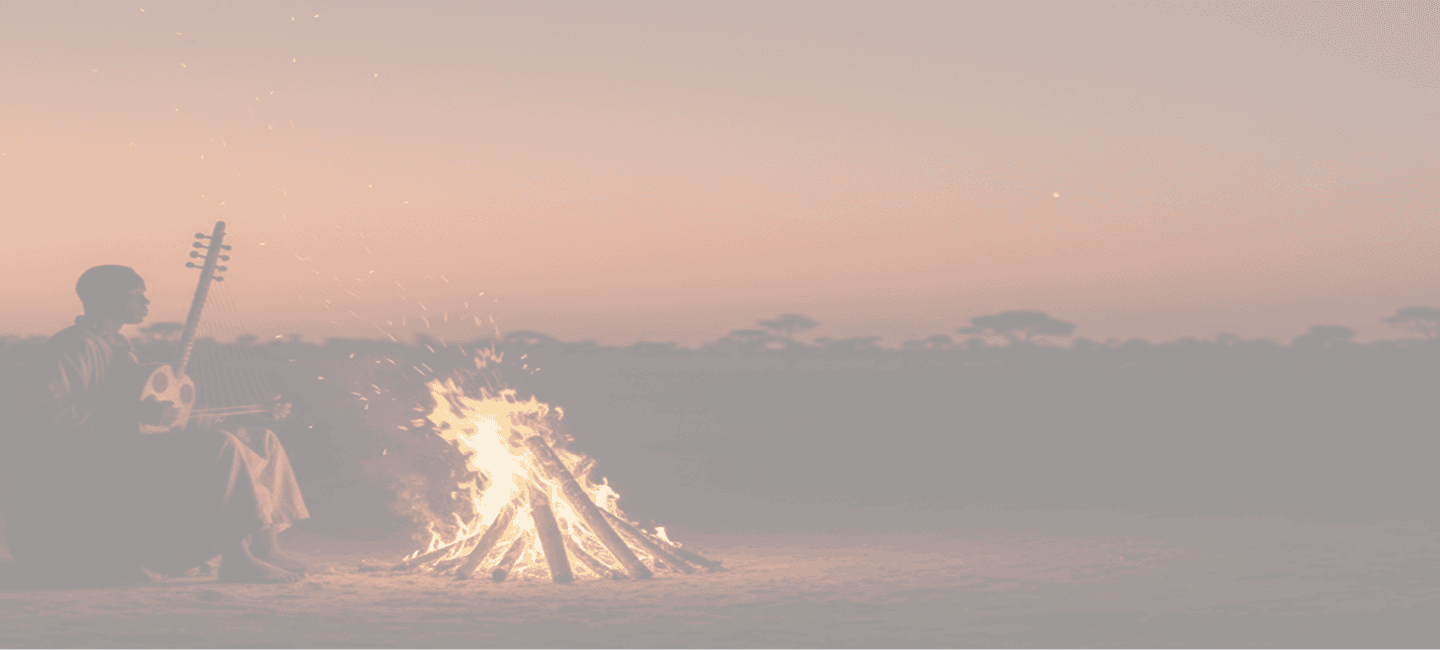 African musician by a campfire in the savanna
